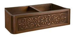 Double bowl copper farmer sink with stylized flower motif