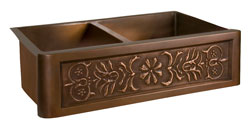 Double bowl copper farmer sink with stylized flower motif