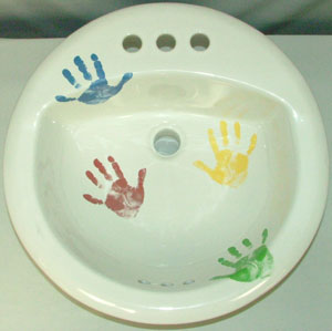 Hand decorated porcelain sink with colorful hand print design