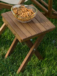example of teak folding seat bench used as side table outside