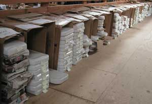 many shelves are filled with water closet tank lids and covers