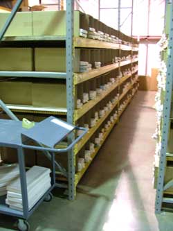 many shelves are filled with water closet tank lids and covers